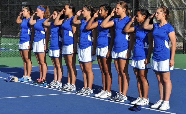 Nine cadets on the Air Force Academy women’s tennis team salute at a match Sept. 22, 2012. The team is 12-5 overall and 1-1 in the Mountain West Conference. The team’s last two home matches will take place April 12 and 14. (U.S. Air Force photo/Liz Copan)