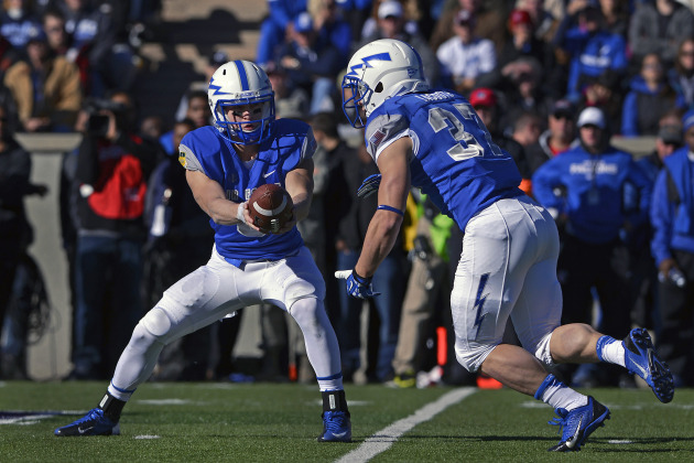 Air Force freshman quarterback Nate Romine hands off to senior running back Anthony LaCoste during the Air Force-Army football game at Falcon Stadium Nov. 2, 2013. LaCoste scored on 73- and 78-yard runs to lead the Falcons over the Black Knights, 42-28. (U.S. Air Force photo/Mike Kaplan)