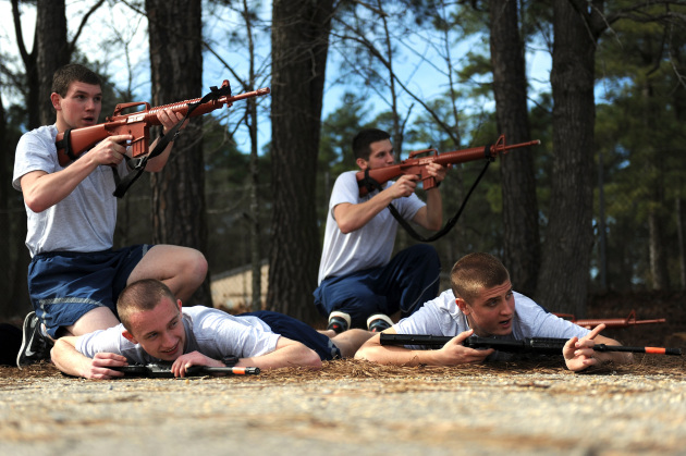 Air Force Reserve Officer Training Corps cadets protect their camp from a simulated attack during a Field Training Preparatory Exercise, Feb. 22, 2014, at Seymour Johnson Air Force Base, N.C. A 45-minute exercise allowed cadets to put their training to use, combining self-aid buddy care, Mission Oriented Protective Posture and teamwork, to defend their camp. (U.S. Air Force photo by Airman 1st Class Aaron J. Jenne)