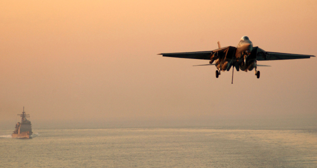 An F-14D Tomcat prepares for an arrested landing aboard the aircraft carrier USS Theodore Roosevelt as the guided-missile cruiser USS San Jacinto conducts plane guard duties, in the Persian Gulf, Jan. 6, 2006. Roosevelt and embarked Carrier Air Wing 8 are underway on a regularly scheduled deployment conducting maritime security operations. U.S. Navy photo by Airman Apprentice Nathan Laird