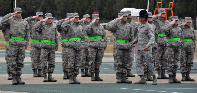 Officer trainees are taught the proper way to salute by Tech. Sgt. Chi Yi, Officer Training School military training instructor, during their first day of drill instruction at OTS. Training instructors teach drill and ceremony to instill discipline, attention to detail and military bearing in the offier trainees. (U.S. Air Force Photo by Staff Sgt. Gregory Brook)