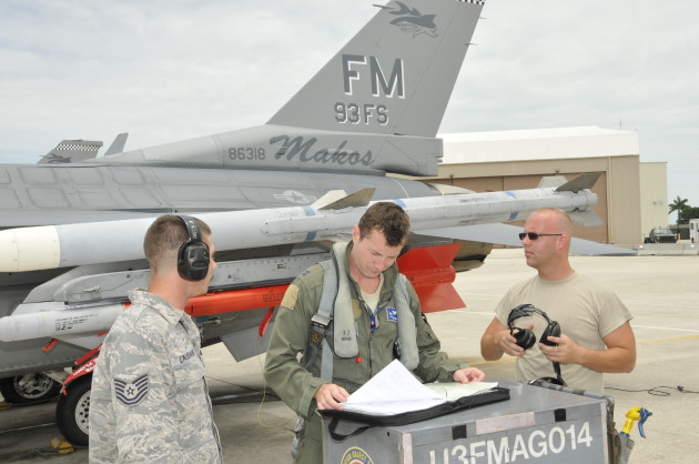 The author checks over the maintenance records for the 93 FS flagship prior to a training sortie at Homestead AFB, FL.