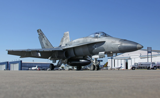 A Boeing F/A-18A+ Hornet from VFA-204 sits on the ramp.