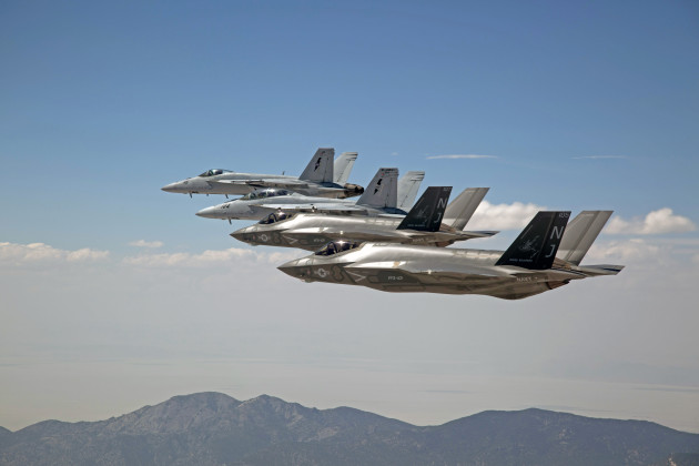 F-35C Lightning IIs, assigned to the Grim Reapers of Strike Fighter Squadron (VFA) 101, and an F/A-18E/F Super Hornets assigned to the Naval Aviation Warfighter Development Center (NAWDC) fly over Naval Air Station Fallon's (NASF) Range Training Complex. VFA 101, based out of Eglin Air Force Base, is conducting an F-35C cross-country visit to NASF. The purpose is to begin integration of F-35C with the Fallon Range Training Complex and work with NAWDC to refine tactics, techniques and procedures (TTP) of F-35C as it integrates into the carrier air wing. (U.S. Navy photo by Lt. Cmdr. Darin Russell/Released)