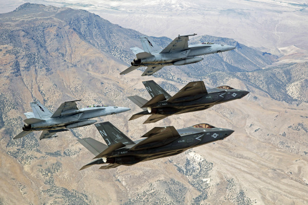 F-35C Lightning IIs, attached to the Grim Reapers of Strike Fighter Squadron (VFA) 101, and an F/A-18E/F Super Hornets attached to the Naval Aviation Warfighter Development Center (NAWDC) fly over Naval Air Station Fallon's (NASF) Range Training Complex. VFA 101, based out of Eglin Air Force Base, is conducting an F-35C cross-country visit to NASF. The purpose is to begin integration of F-35C with the Fallon Range Training Complex and work with NAWDC to refine tactics, techniques and procedures (TTP) of F-35C as it integrates into the carrier air wing. (U.S. Navy photo by Lt. Cmdr. Darin Russell/Released)