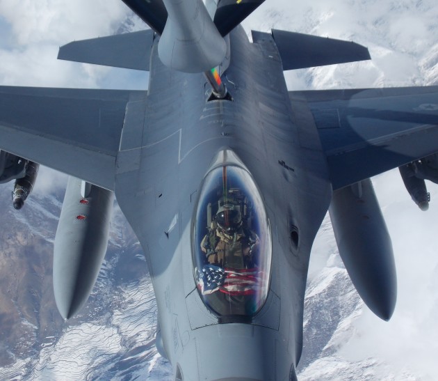 An F-16 pilot from the 482nd FW flies an American Flag over the snowy mountains of Afghanistan in early 2015. (Photo courtesy of Scott Wolff)