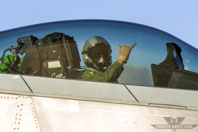 An F-22 Raptor pilot from the 95th Fighter Squadron flashes a reminder to "Push It Up!" as he taxis for takeoff during Red Flag 16-1. (Photo by Scott Wolff)