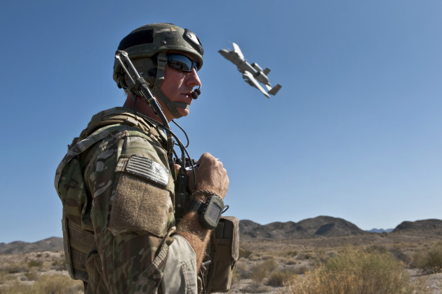 A JointTerminal Attack Controller uses a radio to communicate with pilots of A-10 Thunderbolt II aircraft during a close air support training mission at the Nevada Test and Training Range. USAF photo by Tech. Sgt. Michael R. Holzworth, U.S. Air Force. (Released)