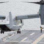 Picture of the Day: Aviation Boatswain’s Mate 2nd Class Jamel Agee signals an MV-22 Osprey