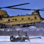 Picture of the Day: Soldiers Attach 155 mm Howitzer to a CH-47 Chinook Helicopter