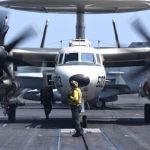 Picture of the Day: Aviation Boatswain’s Mate 3rd Class John Gandy Positions an E-2D Hawkeye